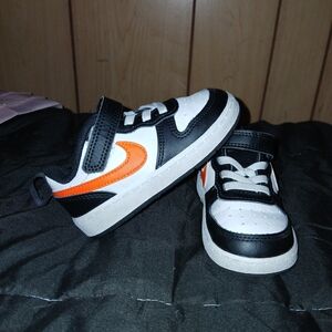 Nike Kids Black and White Sneakers with Orange Swoosh